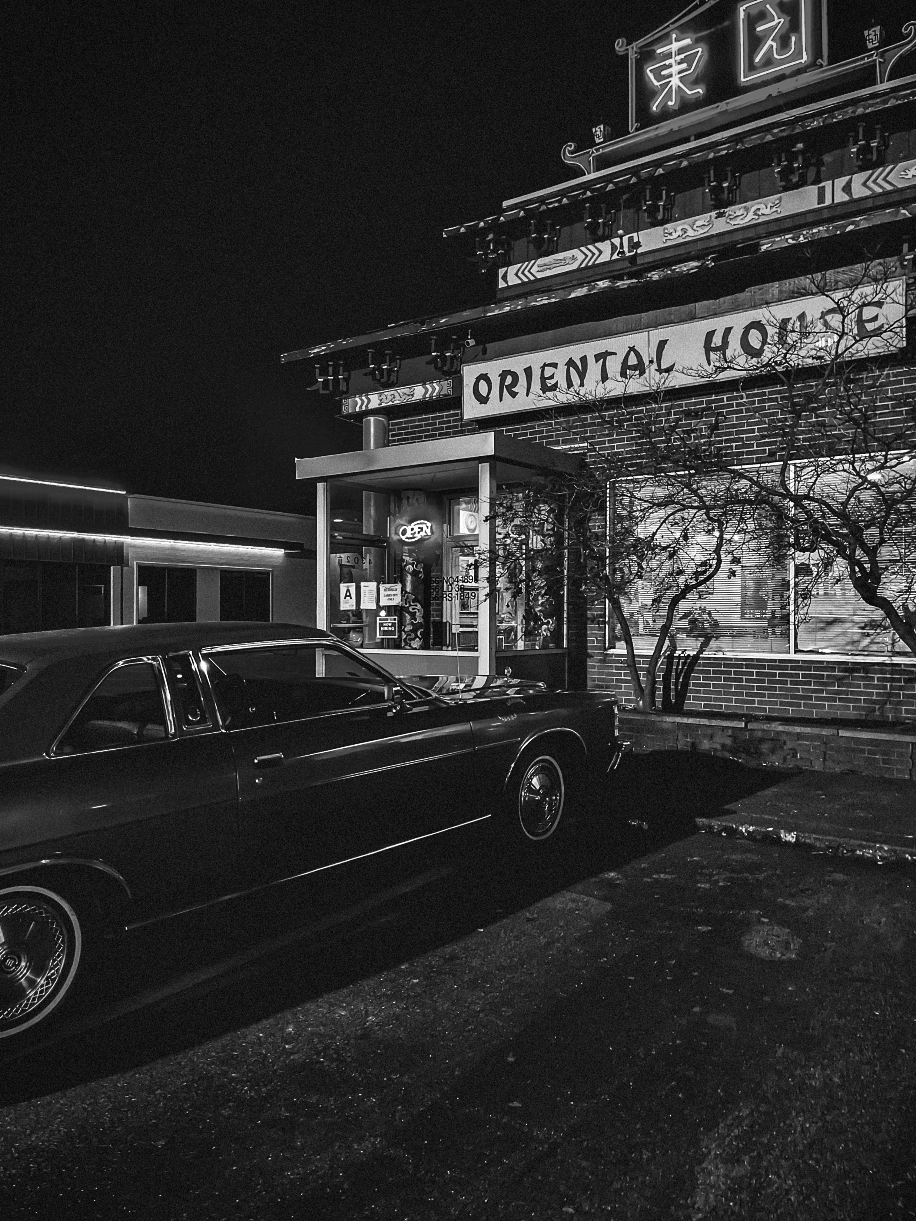Black & White photo of a car in front of a restaurant